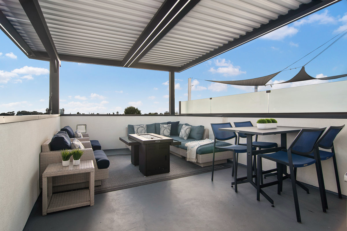 Motorized louvered pergola with adjustable roof slats and integrated lighting for outdoor living.