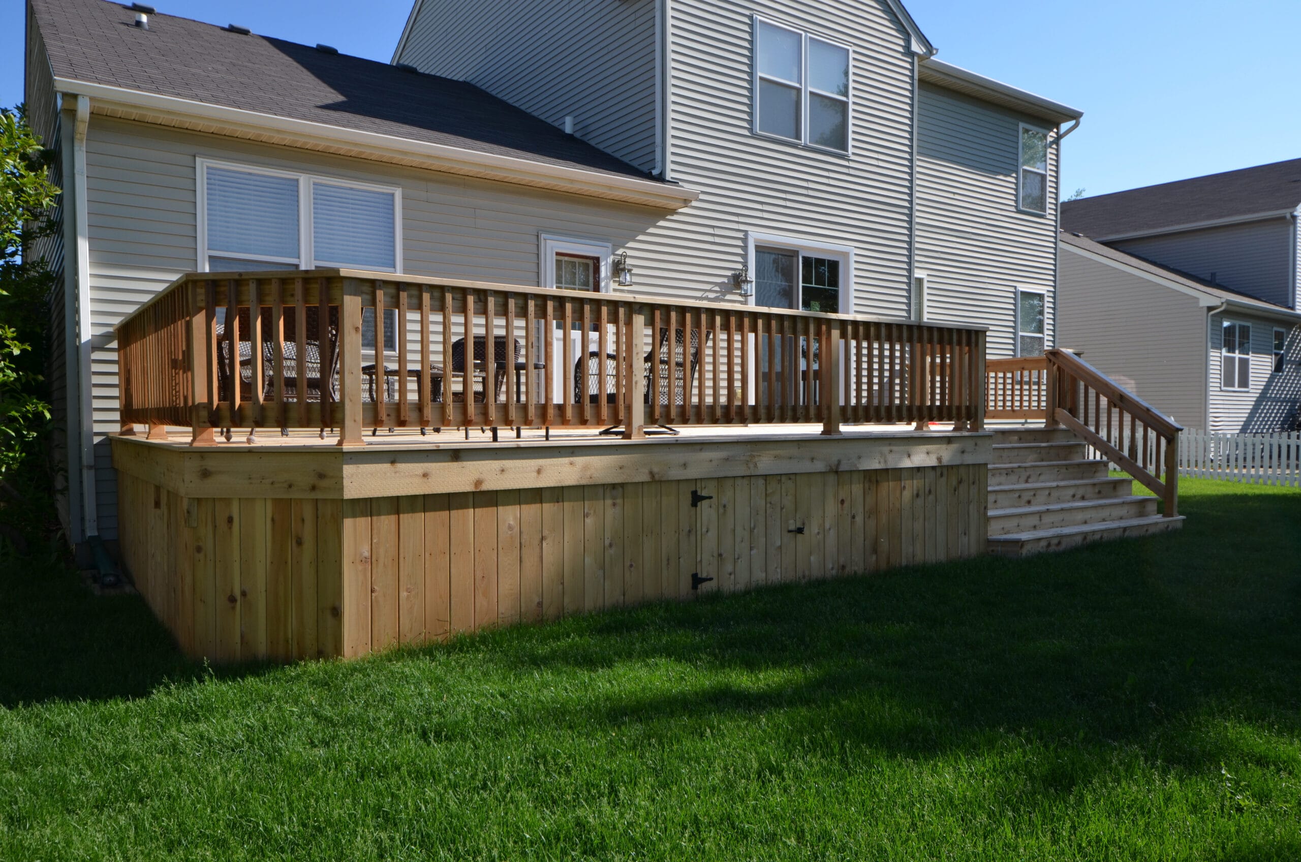 New treated wood deck with vertical wood skirting.